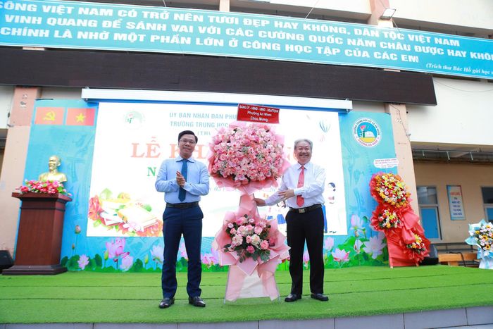 Ông Phạm Trung Kiên, Bí thư Đảng uỷ, Chủ tịch HĐND phường An Nhơn tặng hoa chúc mừng khai giảng năm học mới tại Trường THCS An Nhơn