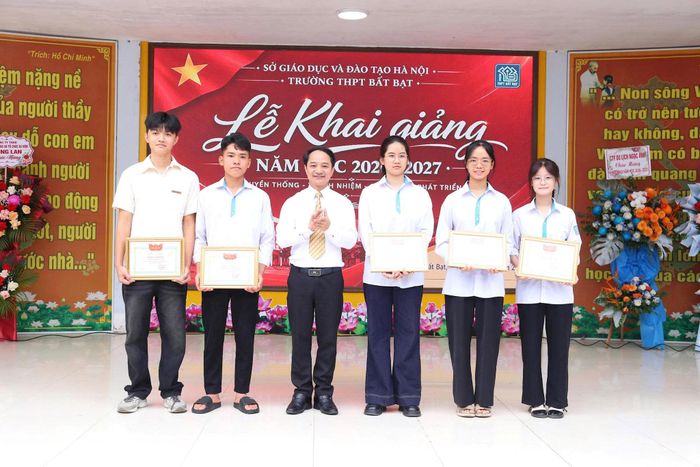 Bí thư Đảng ủy, Chủ tịch HĐND xã Bất Bạt Đỗ Quang Trung trao khen thưởng học sinh đạt thành tích cao trong kỳ thi tốt nghiệp tại Trường THPT Bất Bạt. Ảnh: Khương Tuấn