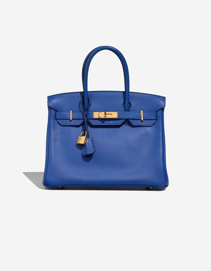 Mẫu túi denim có phom dáng cứng cáp của Gap gợi liên tưởng đến Hermès Birkin. Ảnh: Gap, Hermès.