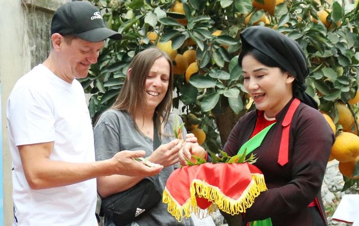 Liền chị quan họ mời trầu du khách quốc tế.