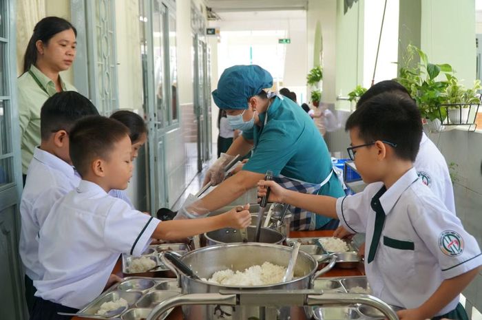  Đến khi kết thúc giờ học buổi sáng, thức ăn được chia vào các dụng cụ chứa và đưa lên các lớp bằng xe đẩy. Học sinh được hướng dẫn ra hành lang nhận thức ăn, tự múc cơm vào khay và lựa chọn phần thức ăn theo nhu cầu, sau đó mang khay về lớp dùng bữa. 