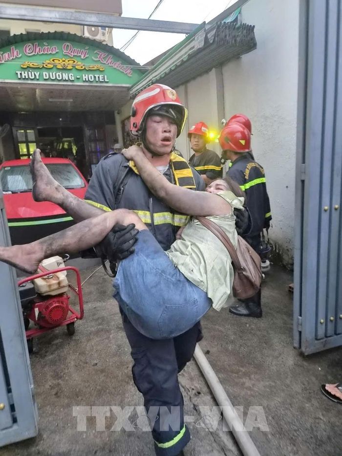 Lực lượng Phòng cháy chữa cháy và Cứu nạn cứu hộ cứu người ra khỏi đám cháy. Ảnh: TTXVN phát 