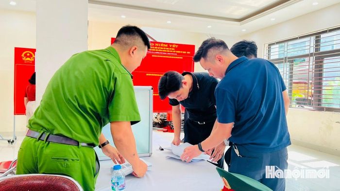 Cán bộ phường Phú Thượng kiểm tra Phiếu lấy ý kiến trước khi phát tới người dân. Ảnh: Cao Kỳ