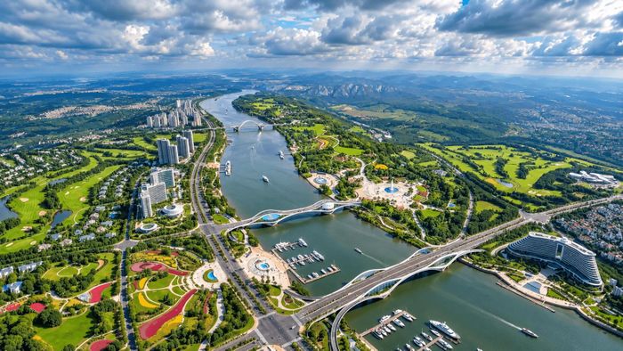 Phối cảnh một không gian đô thị ven sông hiện đại, nơi mặt nước, công viên, giao thông và các khu chức năng được kết nối hài hòa. Ảnh: PV