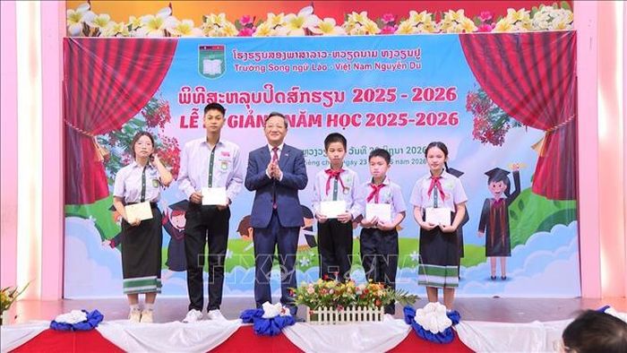 Đại sứ Nguyễn Minh Tâm trao tặng giấy khen cho học sinh đạt thành tích tốt trong kỳ thi học sinh giỏi cấp huyện, cấp thành phố năm học 2025 - 2026 tại Lễ Bế giảng tại Trường Song ngữ Lào - Việt Nam Nguyễn Du, sáng 23/6. Ảnh: Xuân Tú/PV TTXVN tại Lào