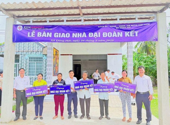 Đại diện Công ty Nhiệt điện Duyên Hải và chính quyền địa phương trao bảng tượng trưng bàn giao Nhà Đại đoàn kết cho các hộ gia đình