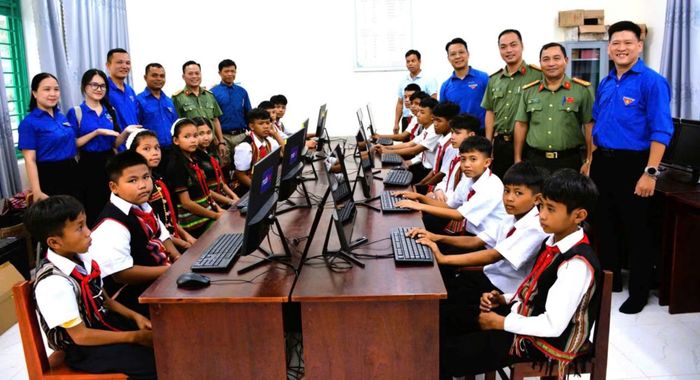 Các đại biểu và các em học sinh tại công trình “Phòng máy tính cho em”.