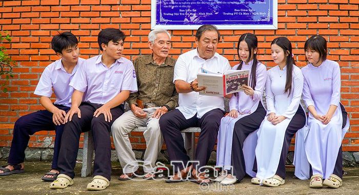 Ông Trần Văn Hiện, nguyên Chủ tịch HĐND tỉnh, nguyên Chủ tịch Uỷ ban MTTQ Việt Nam tỉnh Cà Mau, Trưởng Ban Liên lạc Trường Nội trú Cà Mau - Ninh Bình (bên phải) cùng ông Nguyễn Thành Đa, cựu giáo viên Trường Nội trú Cà Mau - Ninh Bình, chia sẻ với các em học sinh về lịch sử ngôi trường thời kháng chiến