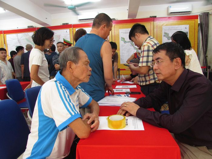 Chủ nhiệm Ủy ban Kiểm tra Đảng ủy phường Hồng Hà Trịnh Chí Thanh trao đổi thông tin với người dân về Điều chỉnh tổng thể Quy hoạch phân khu đô thị sông Hồng. Ảnh: Phương Thảo