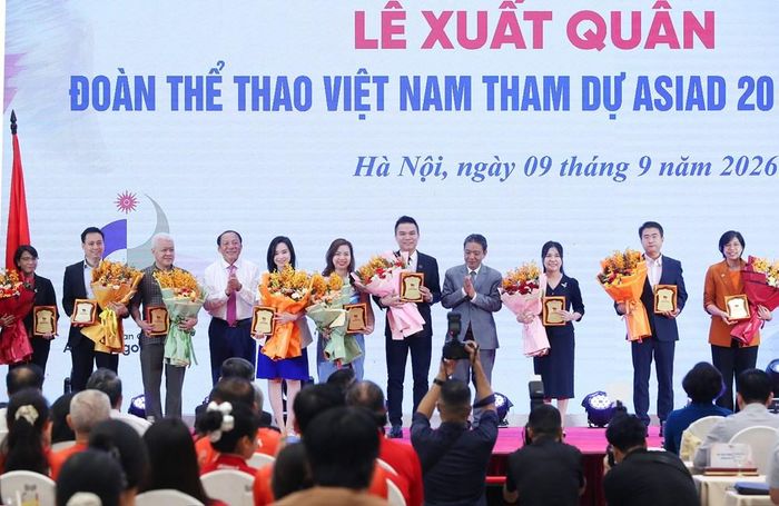Chủ tịch Uỷ ban Olympic Việt Nam Nguyễn Văn Hùng và Thứ trưởng Hoàng Đạo Cương trao Kỷ niệm chương và hoa cho các nhà tài trợ