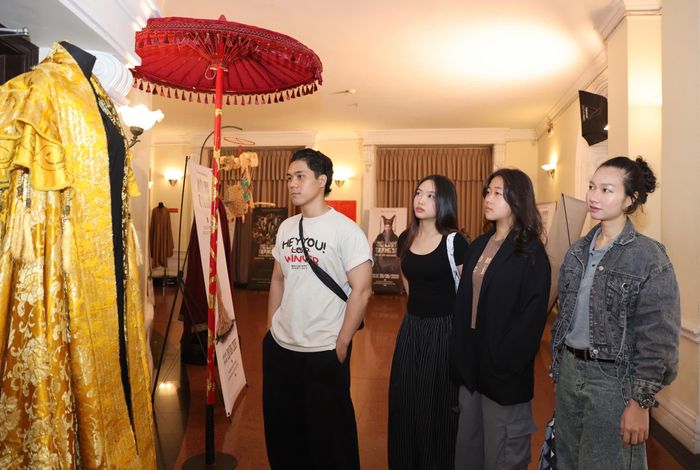 Bạn trẻ tham quan tạo hình trang phục phim "Hộ linh tráng sĩ: Bí ẩn mộ vua Đinh" trưng bày tại tọa đàm. ẢNH: HOÀNG TRIỀU
