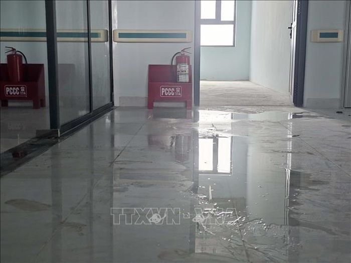 Nước đọng do thấm, dột tại một tầng của tòa nhà. Ảnh: Hưng Thịnh/TTXVN