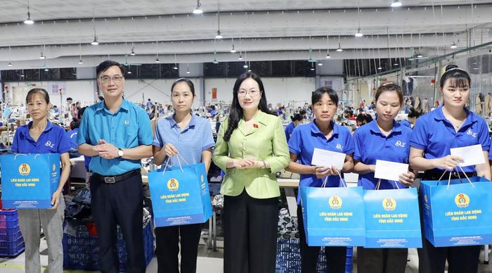  Đồng chí Đỗ Thị Việt Hà và lãnh đạo Liên đoàn Lao động tỉnh trao quà cho công nhân Công ty trách nhiệm hữu hạn Một thành viên Dệt may QT. 