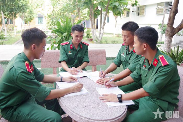 Thượng sĩ Lê Anh Đức Yên (thứ 2, từ trái sang) cùng tổ học phụ trao đổi bài tại đơn vị. 