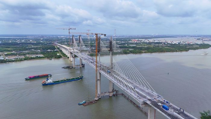 Các đơn vị thi công hoàn thiện mặt cầu. Ảnh: THANH THƯƠNG