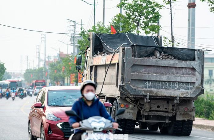 Một số chiếc chở vật liệu đầy tràn trên thùng và che chắn sơ sài khiến nguy cơ vật liệu đất đá rơi vãi xuống đường.