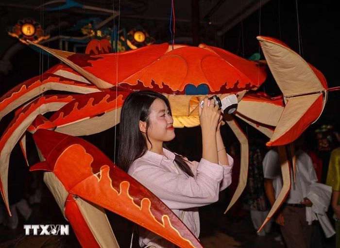 Khách tham quan thích thú khám phá những món đồ chơi gắn với Tết Trung thu truyền thống. (Ảnh: Khánh Hòa/TTXVN)