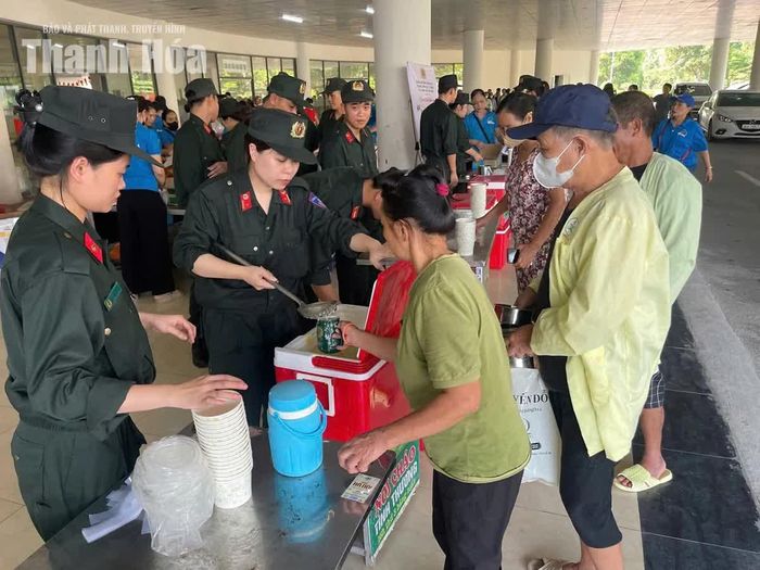 Cán bộ, chiến sĩ Phòng Cảnh sát cơ động Công an tỉnh Thanh Hóa trao cháo cho bệnh nhân tại Bệnh viện Ung bướu tỉnh.