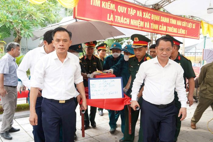 Lãnh đạo phường Chương Mỹ tham gia dẫn hài cốt liệt sĩ từ mộ phần về khu vực lấy mẫu. Ảnh: Lan Oanh
