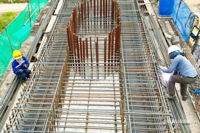 Công nhân hàn, lắp cốt thép trên một trụ cầu đang thi công. Ảnh: T.Anh