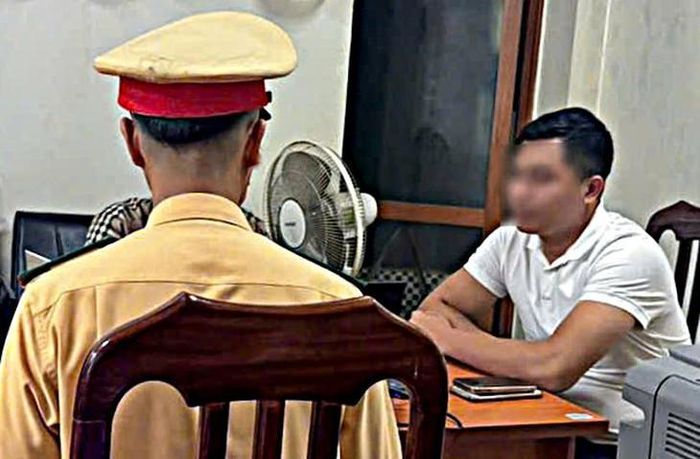 Lái xe khách T.V.H. (áo cam) và lái xe taxi P.Q.Đ. (áo trắng) tại cơ quan Công an. (Ảnh Công an TP Hà Nội)
