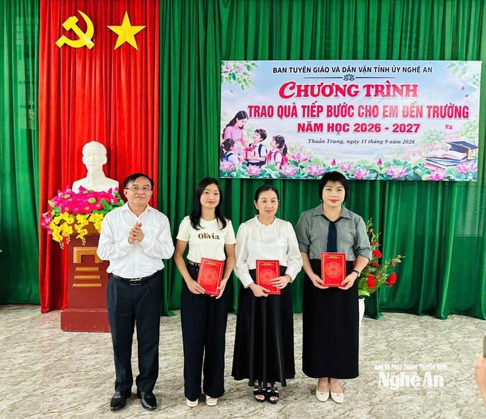 Đồng chí Ngọc Kim Nam trao quà cho các em học sinh thông qua đại diện lãnh đạo nhà trường.