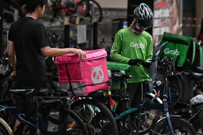Singapore thông qua dự luật mang tính bước ngoặt, công nhận người lao động tự do trong lĩnh vực gọi xe và giao hàng là đối tượng lao động riêng biệt. (Ảnh: The Straits Times)