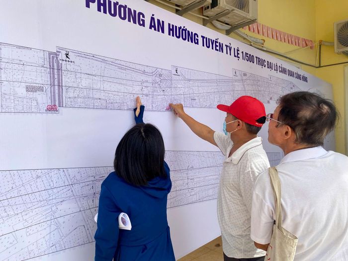 Người dân thôn Hải Bối, xã Vĩnh Thanh tới xem quy hoạch dự án đầu tư xây dựng Trục đại lộ cảnh quan sông Hồng vào sáng 12-9. Ảnh: Lý Thanh