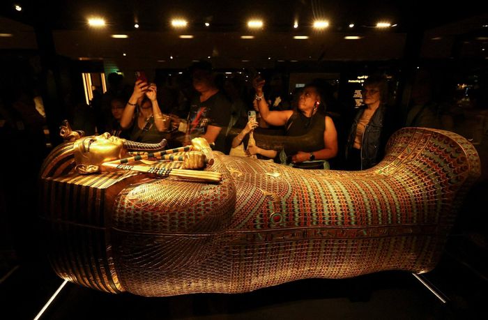 Khách tham quan ngắm quan tài bằng vàng của Pharaoh Tutankhamun bên trong Đại bảo tàng Grand Egyptian. Ảnh: Reuters.