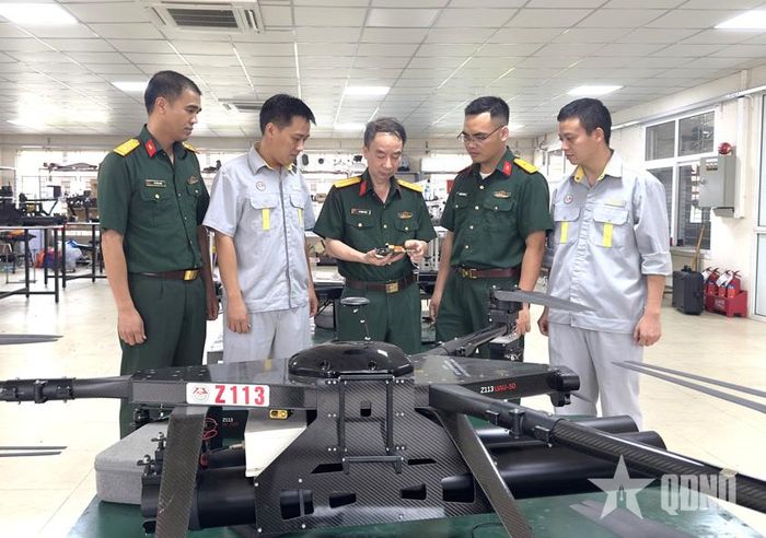 Đại tá Lý Thanh Minh, Phó giám đốc Nhà máy Z113 (đứng giữa) kiểm tra hoạt động sản xuất UAV tại nhà máy. Ảnh: CHIẾN THẮNG