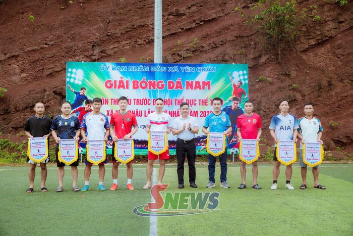 Ban tổ chức trao cờ lưu niệm cho các đội tham gia thi đấu bóng đá nam.
