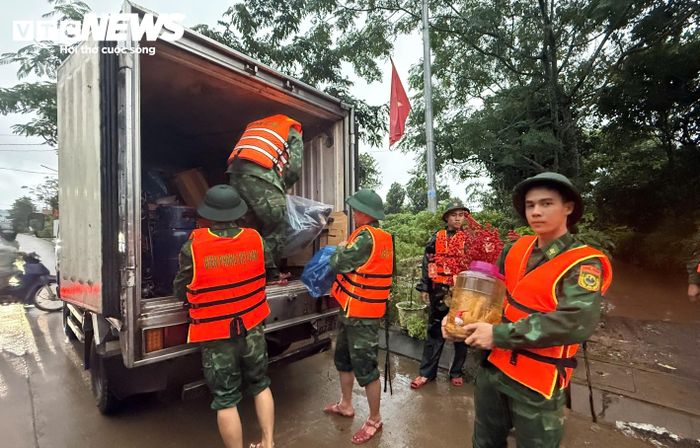 Tài sản của người dân được đưa lên xe tải chở đến nơi cao hơn.