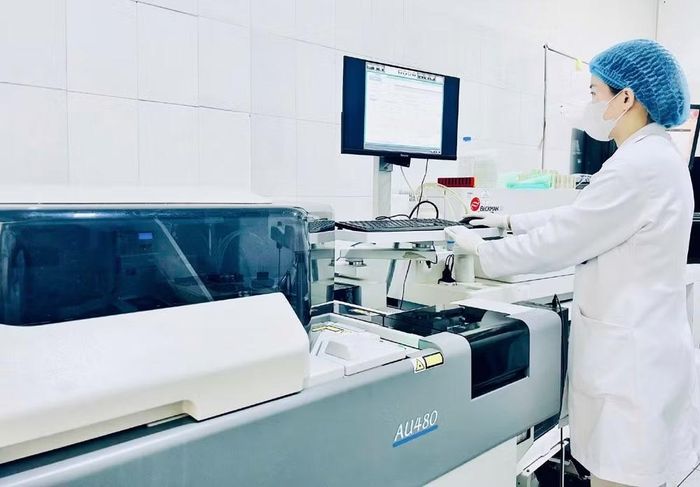 Bác sĩ Trung tâm Y tế khu vực Tam Dương thực hiện kỹ thuật xét nghiệm trên hệ thống máy sinh hóa tự động kết nối 2 chiều với phần mềm LIS-EMR. (Ảnh: NGỌC LONG)