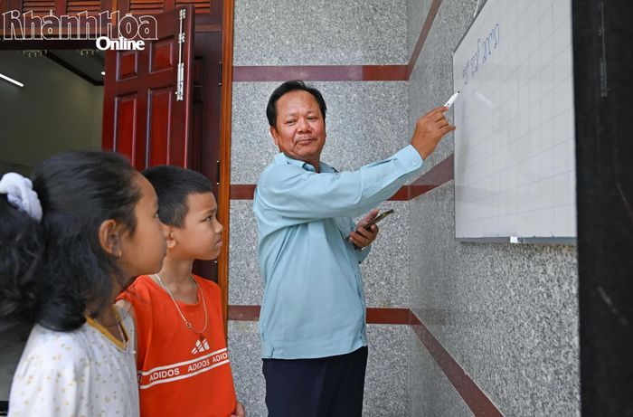 Ông Bá Bình Yên hướng dẫn các cháu học chữ Chăm.