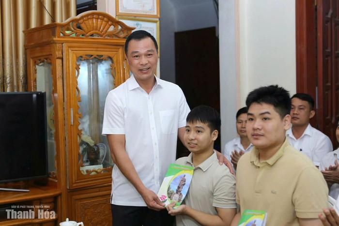 Chủ tịch UBND tỉnh Tô Anh Dũng tại buổi chúc mừng em Ngô Văn Hiếu và Nguyễn Tất Minh. Ảnh: báo Thanh Hóa 