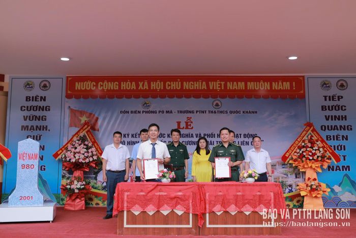 Đại diện Đồn Biên phòng Pò Mã và đại diện Trường Phổ thông nội trú Tiểu học và THCS Quốc Khánh thực hiện nghi thức ký kết