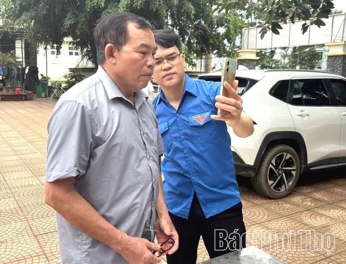 Đoàn viên xã Mường Vang hướng dẫn người dân sử dụng các tiện ích trên điện thoại thông minh.