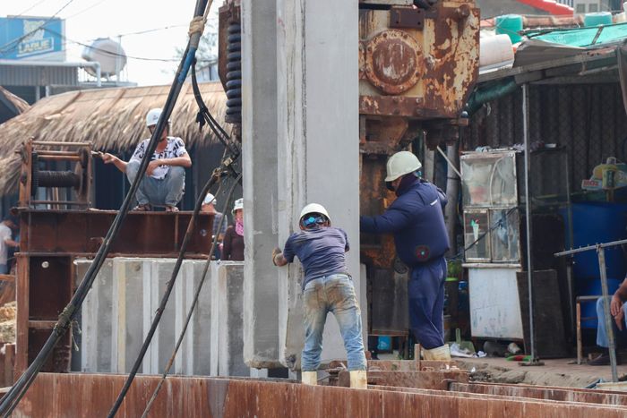 Trong sáng 15/9, hàng chục cọc bê tông tiếp tục được đóng xuống bờ sông Thu Bồn.