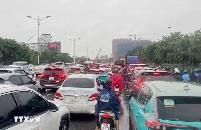 Các phương tiện nối đuôi nhau nhích từng mét do ùn tắc cục bộ trên đường Đàm Quang Trung (phường Long Biên), đoạn từ cầu vượt Vĩnh Tuy đến ngã tư Cổ Linh - Đàm Quang Trung do ngập và các công trình đang thi công. (Ảnh: Phan Phương/TTXVN)