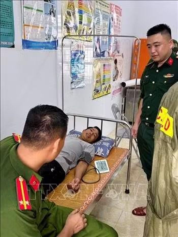 Lực lượng Công an, quân đội thăm hỏi động viên người dân bị mắc kẹt trong hang sau khi được giải cứu. Ảnh: TTXVN phát