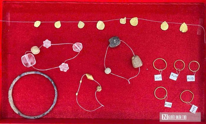 Đáng chú ý là nhóm kim loại màu vàng bao gồm: hạt chuỗi nhỏ, hạt chuỗi đa giác, lá (hay cánh hoa), đi kèm với đó là các mảnh thủy tinh phủ kim loại độc đáo. Đây là những chứng tích quan trọng phản ánh đỉnh cao nghệ thuật chế tác kim hoàn cổ đại. Đáng chú ý, các hạt chuỗi vàng phát hiện trong ngôi M2 có đặc điểm tương đồng với những hạt chuỗi vàng tại khu mộ Hợp Phố (Trung Quốc), chùa Wangheungsa (Hàn Quốc), Khao Sam Kaeo (Thái Lan) và Óc Eo (Việt Nam), cho thấy sự tương đồng về loại hình và kỹ thuật chế tác giữa các địa điểm.