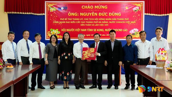 Chủ tịch HĐND thành phố Nguyễn Đức Dũng cùng đoàn công tác tặng quà cho Hội Người Việt Nam tỉnh Sê Kông. Ảnh: HOÀN VŨ - VĂN HÙNG