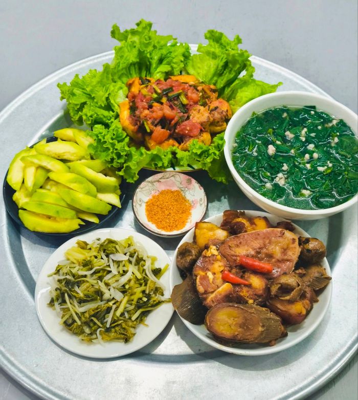 Mâm cơm gia đình đơn giản và bắt mắt với món đậu nhồi thịt sốt cà chua, cá trắm kho chuối, canh rau ngót, dưa muối... Ảnh: Minh Nguyễn