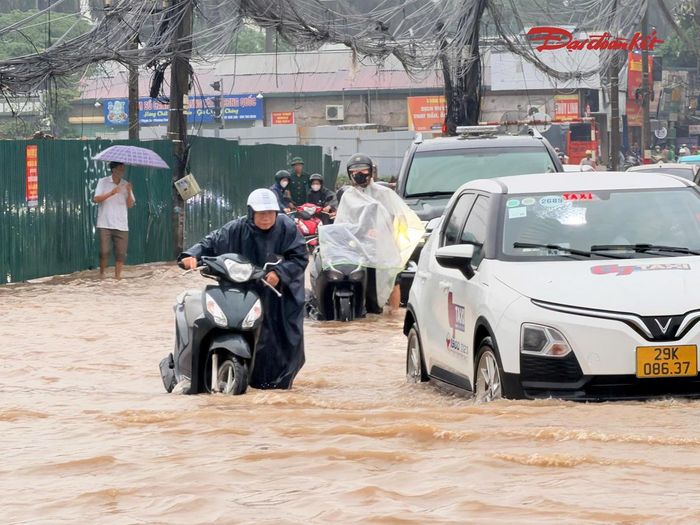 Tương tự, tại khu vực đường 70 qua Khu đô thị Xa La, nước cũng dâng cao sau trận mưa lớn kéo dài trong đêm. Nhiều đoạn đường bị nước bao phủ, phương tiện di chuyển qua đây gặp không ít trở ngại, đặc biệt là xe máy.