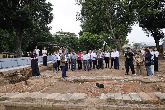 Các chuyên gia tại hố khai quật trên nền đền Kính Thiên sáng 14/9. Ảnh: HTTL