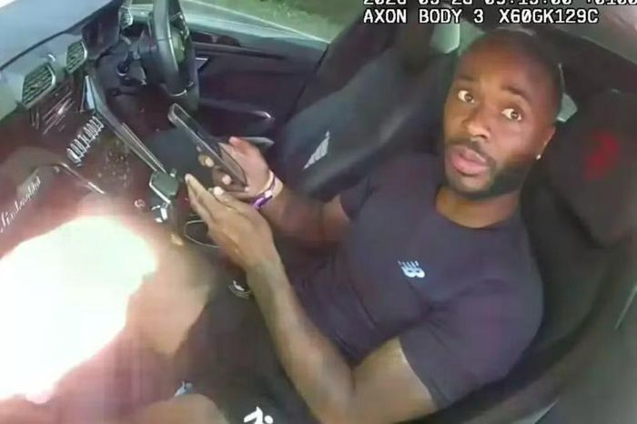 Sterling ngồi trong xe trả lời các câu hỏi của cảnh sát sau vụ làm "quái xế" ở cao tốc.