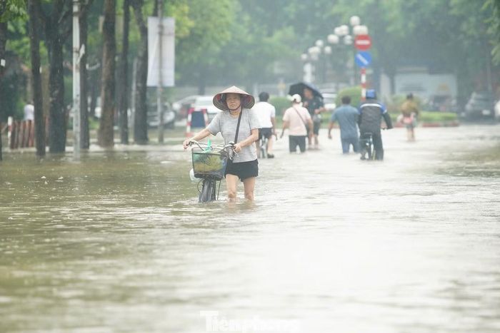 Chiều 17/9, khu vực ven hồ Văn Quán vẫn ngập sâu, nước phủ kín nhiều đoạn đường, ảnh hưởng việc đi lại của người dân.