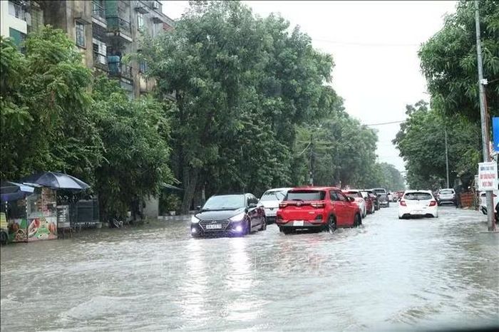 Đường Lê Trang Tông ngập sâu khiến các phương tiện di chuyển khó khăn, dẫn đến ùn ứ phương tiện cục bộ.