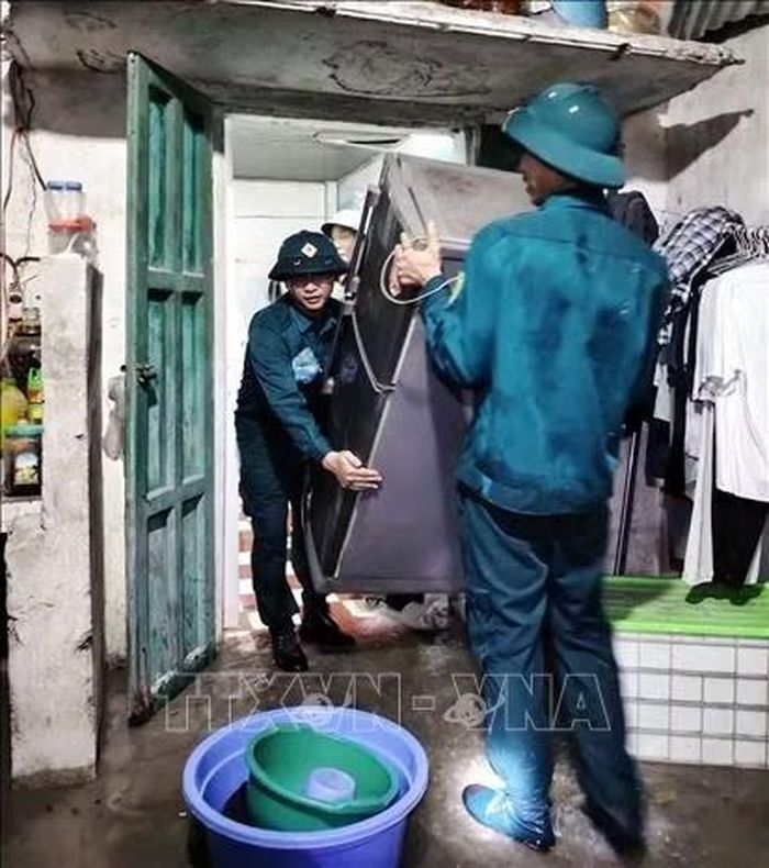 Ban quân sự Phường Châu Sơn tham gia giúp dân di chuyển đồ đạc đến nơi an toàn do mưa ngập khu vực sông Đáy.