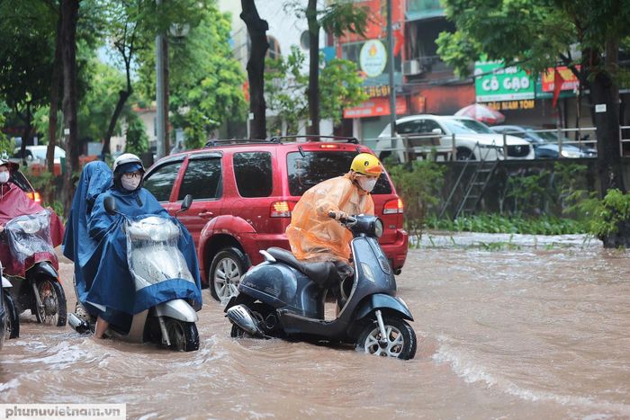 Lòng đường biến thành sông, hàng trăm người đi làm đành dò dẫm từng bước để đảm bảo không gặp phải các vật cản khuất tầm nhìn